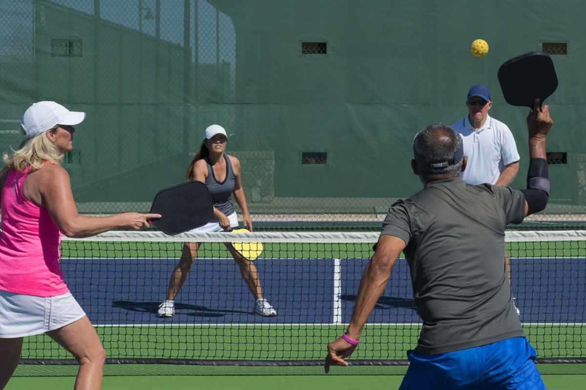 Pickleball Mixed doubles action of colorful court.