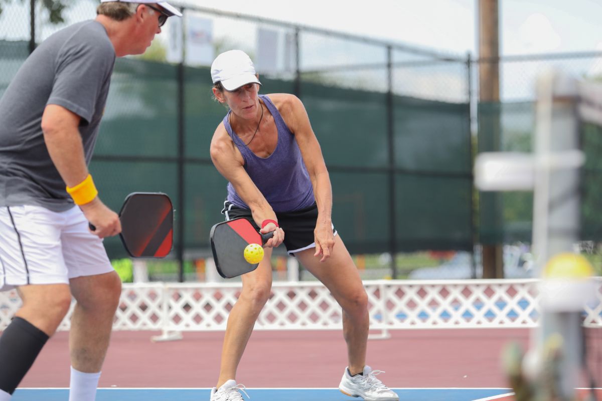 A couple of playing double in a pickleball match.