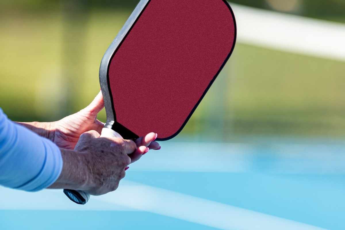 Athlete demonstrates the pickleball ready position for the paddle.